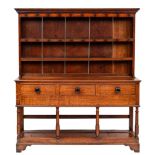 A 19th Century oak dresser:, the shelved superstructure with a moulded cornice,