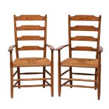 Cotswold School - A pair of oak Clissett ladder back armchairs in the manner of Edward Gardiner: