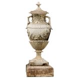 A large reconstituted stone garden urn: of neoclassical outline,