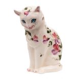 An Exon Ware Wemyss pottery cat: modelled seated with inset blue glass eyes and painted with sweet