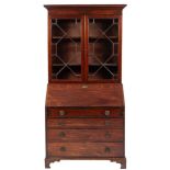 An early 19th Century mahogany bureau and associated bookcase:,