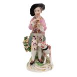 A Derby figure of a boy musician: wearing a puce jacket and floral breeches,