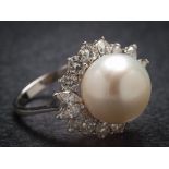 An 18ct white gold cultured pearl and diamond cluster ring: the central cultured pearl