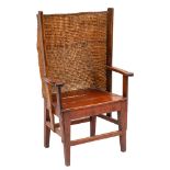 A 19th Century oak and pine Orkney Islands wing armchair:, having a curved ropework back,