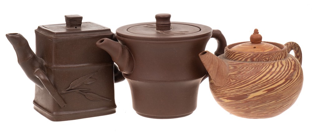 Two small Chinese Yixing stoneware teapots: of dark brown hue and of circular and rectangular