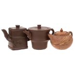 Two small Chinese Yixing stoneware teapots: of dark brown hue and of circular and rectangular