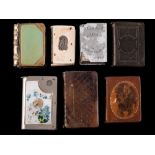 A collection of seven assorted book-shaped vesta cases: including ivory and horn examples (7).