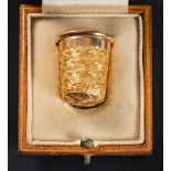 A 15ct gold thimble: with foliate decoration, stamped '7', approximately 5.