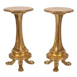 A pair of carved giltwood circular pedestal tables:, the tops with egg and dart borders,