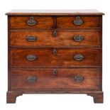 A George III mahogany rectangular chest: the top with a moulded edge containing two short and three