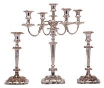 An electroplated four branch candelabra: with urn-shaped nozzles on swept reeded branches,