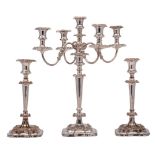 An electroplated four branch candelabra: with urn-shaped nozzles on swept reeded branches,