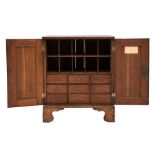 An early 19th Century oak table stationery cabinet:, with a reeded cornice,