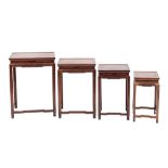 A set of Chinese rosewood quartetto tables:, having rectangular tops and cloud band aprons,