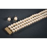 A cultured pearl three-string necklace: the cultured pearls approximately 7mm diameter and on