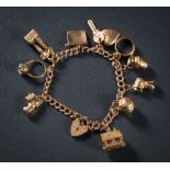 A 9ct gold charm bracelet: with various attached gold charms to include single stone ring and key,