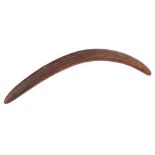 A late 19th century Aboriginal boomerang: of traditional design with incised decoration to one side,