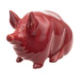 A Robert Heron & Sons Wemyss Ware pottery pig: modelled seated under a burgundy glaze,
