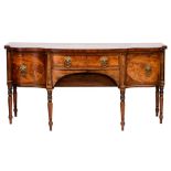 A Regency mahogany and inlaid sideboard:, of shaped serpentine fronted outline,