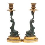 A pair of Regency style brass and bronzed metal metal candlesticks: with urn -shaped nozzles,