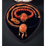 A mid 19th Century coral relief mounted necklace: the central coral panel 32mm long x 24mm wide