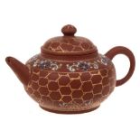 A small Chinese Yixing stoneware teapot: of light brown hue with squat body,