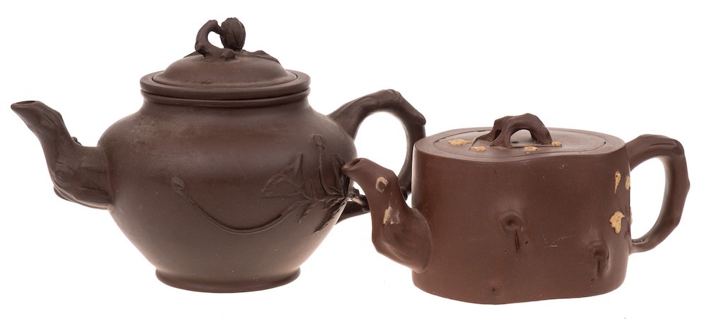 Two Chinese Yixing stoneware teapots: one of dark brown hue with rustic handle,