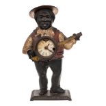 A Victorian American Blinking Eye automata clock: the cast iron case depicting a banjo player in