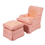 A fully upholstered armchair:, in a coral coloured trailing foliate design with loose cushion seat,