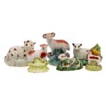 A group of six pearlware and other earthenware models of sheep: three standing,