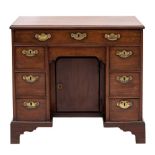 A mid 18th Century mahogany kneehole desk:, the rectangular top with a moulded edge,