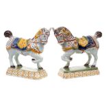 A pair of Dutch polychrome delftware models of horses: each with one foreleg raised and sporting