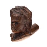 A late 19th Century carved wooden pipe bowl: in the form of a woman's head with a large ribbon bow