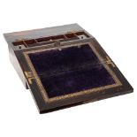 A Victorian coromandel and brass mounted lap desk: the hinged lid enclosing a velvet lined writing