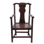 An 18th Century oak open armchair:, the back with shaped toprail and solid vase shaped splat,