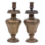 A pair of 19th Century bronze candlesticks: with plain cylindrical nozzles,