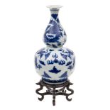 A Chinese blue and white double gourd 'Dragon' vase: painted overall with dragons chased flaming