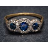 A sapphire and diamond triple cluster ring: the graduated circular sapphires within a surround of