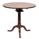 A mid 18th Century mahogany circular tea table:, the snap top on turned central pillar,