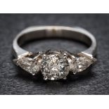 A platinum and diamond three-stone ring: with central cushion-shaped old brilliant-cut diamond