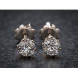 A pair of 18ct white gold and diamond ear-studs: each with a circular brilliant-cut diamond