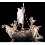 A Continental model of two cherubs in a sailing boat, bears import marks for Berthold Muller,