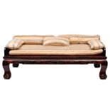 A large Chinese hardwood day bed: the shaped three quarter back and elbow supports over a reeded