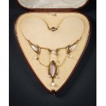 An Art Nouveau gold and mother of pearl necklace: of openwork whiplash links inset with mother of