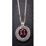 An 18ct white gold, ruby and diamond mounted pendant: with central oval ruby approximately 6.