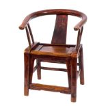 A Chiense elm armchair: of curved outline with solid central splat and panelled seat,