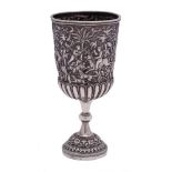 An Indian silver cup: the bowl with embossed hunting scene and half reeded decoration,