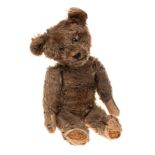 An early 20th century brown plush Teddy bear: with boot button eyes,