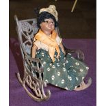 A SFBJ black bisque head doll:, together with a cast iron rocking chair.