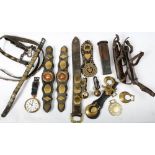 A collection of late 19th/early 20th century horse brasses and tack: and a pair of wooden soled ice